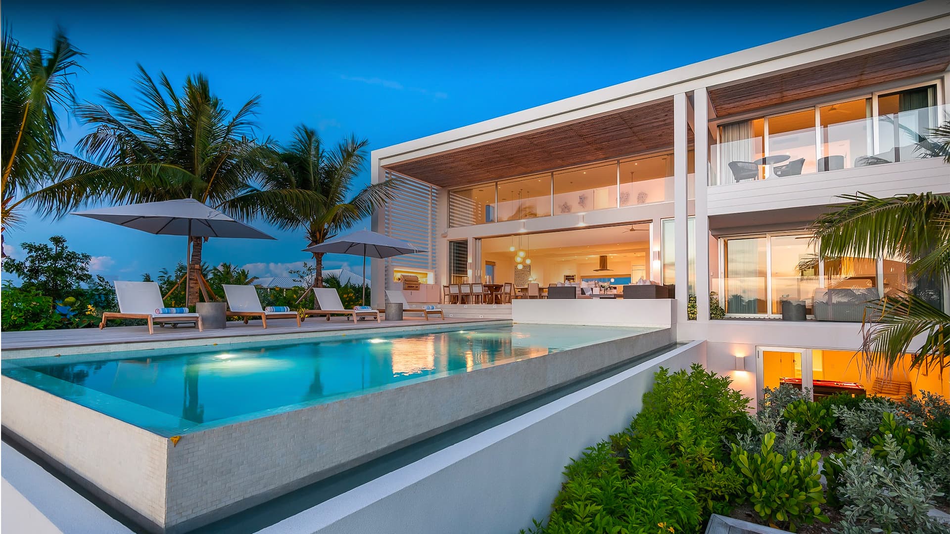 Beachfront villa and still pool at dusk — work photography for Beach Enclave